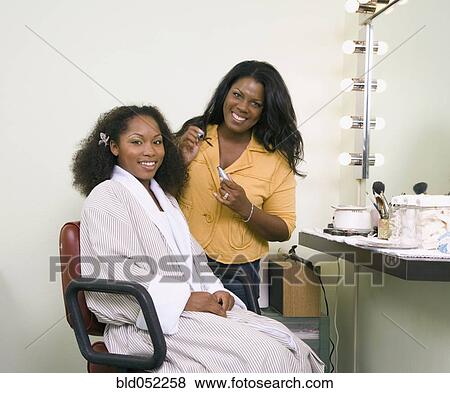 Stock Photo - African woman having makeup applied. Fotosearch