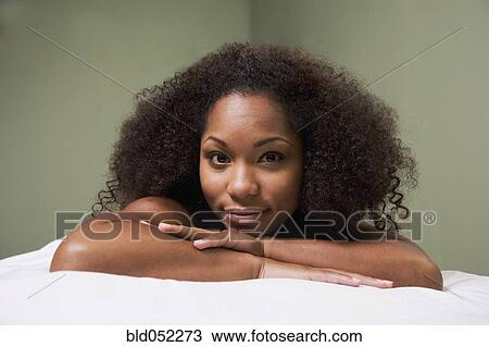 African woman laying on massage table View Large Photo Image Stock Image - African woman laying on massage table. Fotosearch
