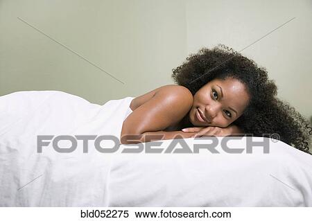 African woman laying on massage table View Large Photo Image Stock Photography - African woman laying on massage table. Fotosearch