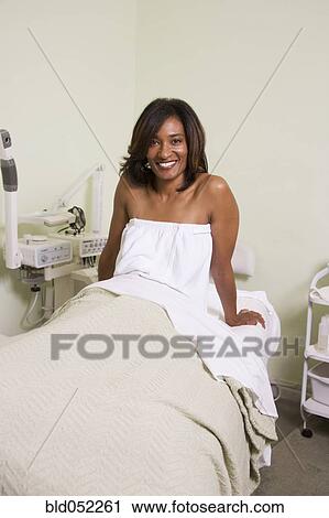 Stock Image - African woman on spa treatment table. Fotosearch
