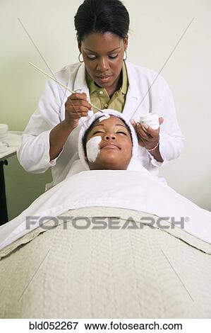 African woman receiving spa facial treatment View Large Photo Image Stock Photo - African woman receiving spa facial treatment. Fotosearch