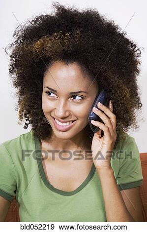 Stock Photo - African woman talking on cell phone. Fotosearch