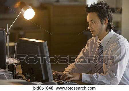 Asian businessman typing on computer View Large Photo Image Stock Photo - Asian businessman typing on computer. Fotosearch