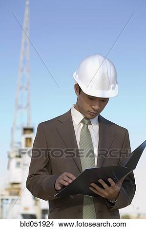 Picture - Asian businessman wearing hardhat. Fotosearch
