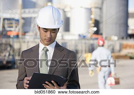 Asian businessman wearing hardhat View Large Photo Image Stock Image - Asian businessman wearing hardhat. Fotosearch