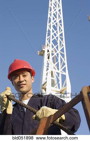 Asian male construction worker wearing hardhat View Large Photo Image Stock Photo - Asian male construction worker wearing hardhat. Fotosearch