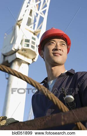Asian male construction worker wearing hardhat View Large Photo Image Stock Photo - Asian male construction worker wearing hardhat. Fotosearch