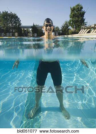 Asian man standing in swimming pool View Large Photo Image Stock Photo - Asian man standing in swimming pool. Fotosearch