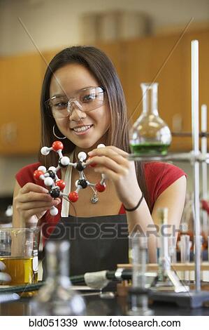 Stock Photo - Asian teenaged girl in science class. Fotosearch