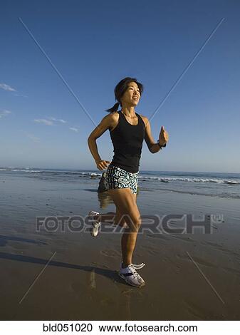 Asian woman running at beach View Large Photo Image Stock Image - Asian woman running at beach. Fotosearch