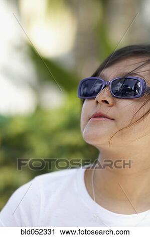 Stock Image - Asian woman wearing sunglasses. Fotosearch