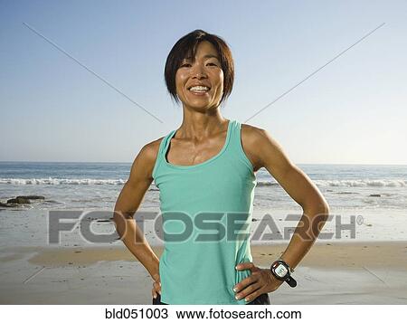 Stock Image - Asian woman with hands on hips. Fotosearch
