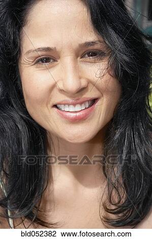 Stock Image - Close up of Hispanic woman smiling. Fotosearch