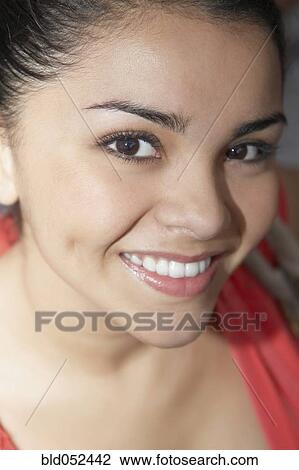 Stock Image - Close up of Hispanic woman smiling. Fotosearch