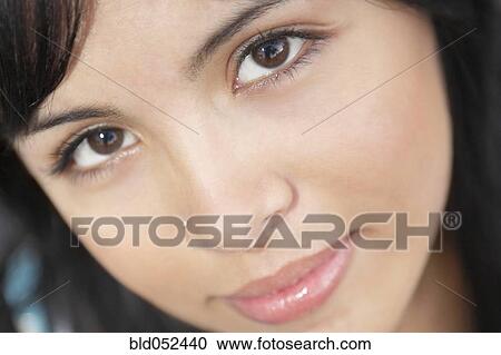 Stock Image - Close up of Hispanic woman with nose ring. Fotosearch