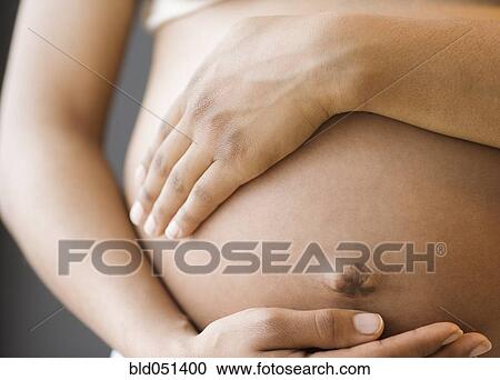 Close up of pregnant African American woman’s belly View Large Photo Image Stock Image - Close up of pregnant African American woman’s belly. Fotosearch
