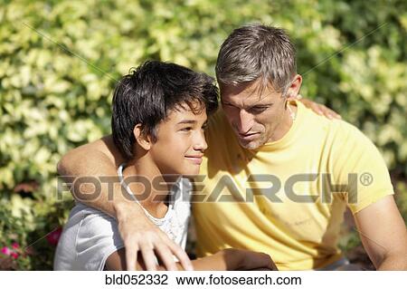 Father and son hugging View Large Photo Image Stock Image - Father and son hugging. Fotosearch