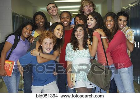 Picture - Group of multi-ethnic teenagers in school hallway. Fotosearch
