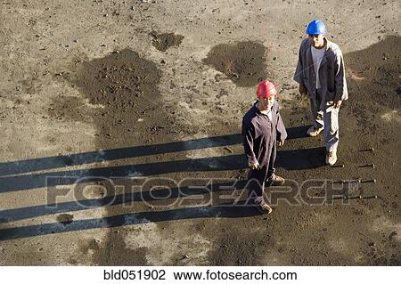 Stock Image - High angle view of multi-ethnic construction workers. Fotosearch