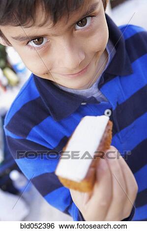 Hispanic boy holding bread and cheese View Large Photo Image Stock Photograph - Hispanic boy holding bread and cheese. Fotosearch
