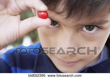 Hispanic boy holding piece of candy View Large Photo Image Stock Photography - Hispanic boy holding piece of candy. Fotosearch