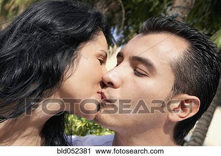 Stock Image - Hispanic couple kissing. Fotosearch