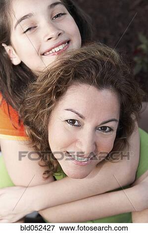 Hispanic girl hugging mother View Large Photo Image Stock Photo - Hispanic girl hugging mother. Fotosearch
