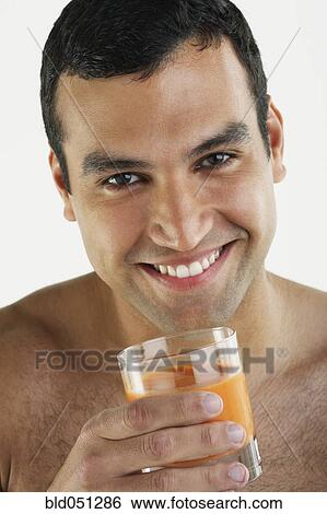 Stock Photograph - Hispanic man drinking juice. Fotosearch