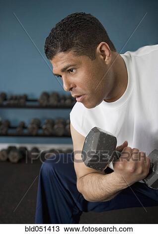 Hispanic man lifting weights View Large Photo Image Stock Image - Hispanic man lifting weights. Fotosearch