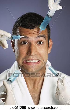 Hispanic man receiving injections in face View Large Photo Image Stock Photo - Hispanic man receiving injections in face. Fotosearch
