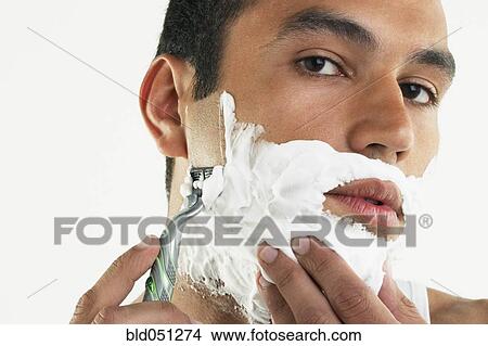 Hispanic man shaving face View Large Photo Image Picture - Hispanic man shaving face. Fotosearch