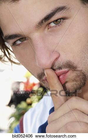 Hispanic man shushing View Large Photo Image Stock Photograph - Hispanic man shushing. Fotosearch