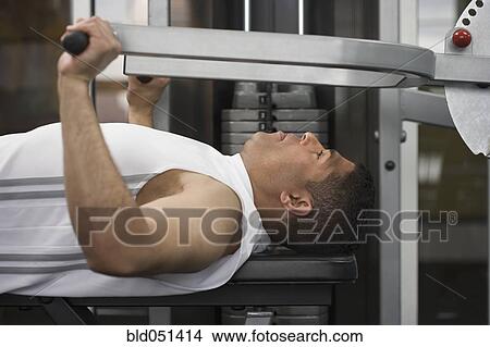 Hispanic man using exercise machine View Large Photo Image Picture - Hispanic man using exercise machine. Fotosearch