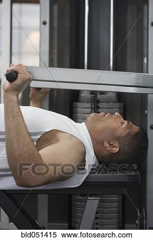 Hispanic man using weight machine View Large Photo Image Stock Photography - Hispanic man using weight machine. Fotosearch