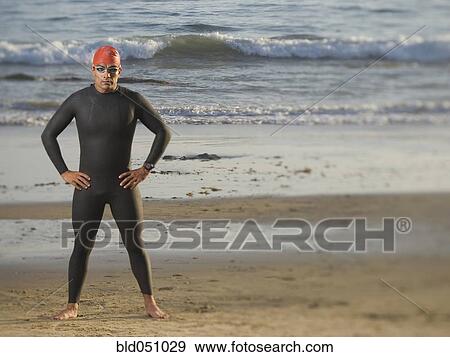 Stock Photo - Hispanic man wearing wetsuit and goggles. Fotosearch