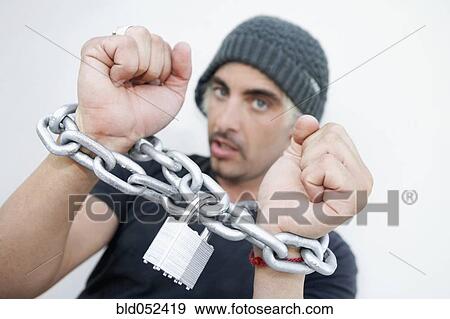 Hispanic man with chains around wrists View Large Photo Image Stock Photo - Hispanic man with chains around wrists. Fotosearch