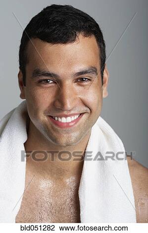 Stock Image - Hispanic man with towel around neck. Fotosearch