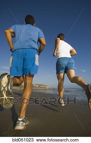 Hispanic men running at beach View Large Photo Image Stock Image - Hispanic men running at beach. Fotosearch