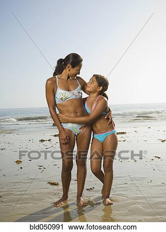 Stock Image - Hispanic mother and daughter hugging. Fotosearch