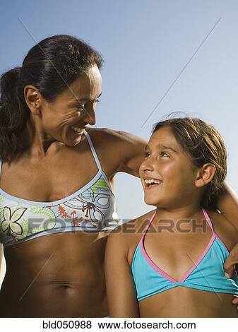 Hispanic mother and daughter smiling at each other View Large Photo Image Stock Photo - Hispanic mother and daughter smiling at each other. Fotosearch