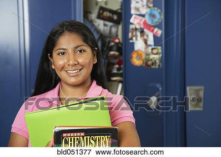 Hispanic teenaged girl in front of school locker View Large Photo Image Stock Photo - Hispanic teenaged girl in front of school locker. Fotosearch
