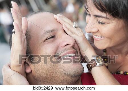 Hispanic woman covering husband’s eyes View Large Photo Image Stock Photo - Hispanic woman covering husband’s eyes. Fotosearch