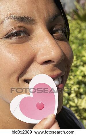 Hispanic woman holding cut-out hearts View Large Photo Image Stock Photo - Hispanic woman holding cut-out hearts. Fotosearch