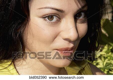 Stock Image - Hispanic woman pursing lips. Fotosearch