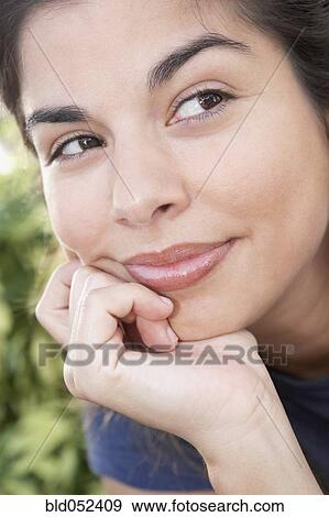 Hispanic woman resting chin on hand View Large Photo Image Stock Photo - Hispanic woman resting chin on hand. Fotosearch