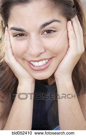 Hispanic woman resting chin on hands View Large Photo Image Stock Image - Hispanic woman resting chin on hands. Fotosearch