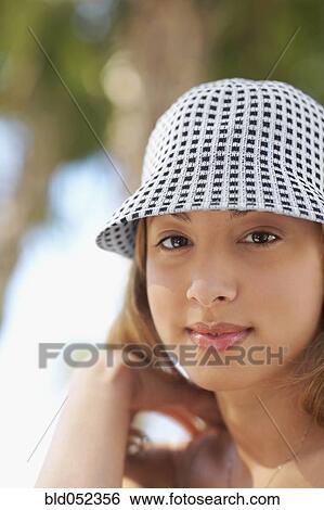 Stock Photograph - Hispanic woman wearing hat. Fotosearch