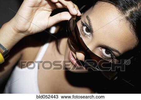 Stock Image - Hispanic woman wearing sunglasses. Fotosearch