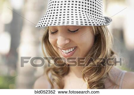 Stock Image - Hispanic woman with eyes closed. Fotosearch