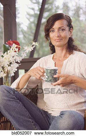 Stock Photo - Mature woman holding coffee mug. Fotosearch